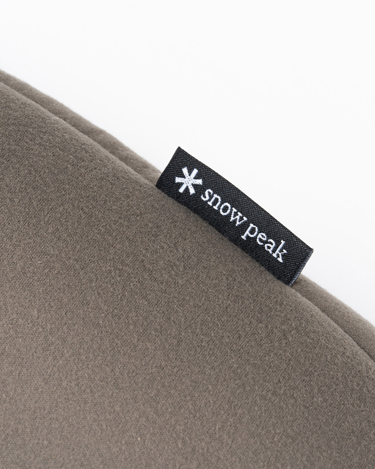 Air Pillow, close-up of the plush face and Snow Peak label