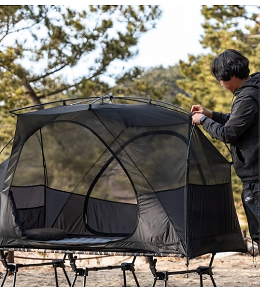 Camper zipping the Base Cot Tent door shut