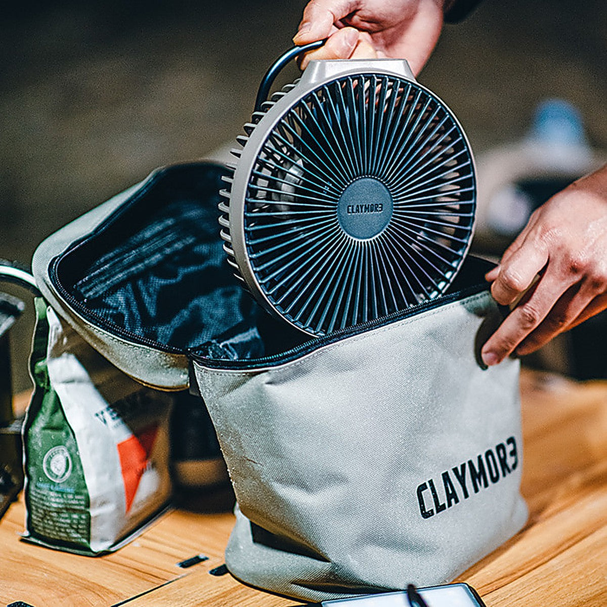 Lifting the V600+ fan out of the open grey case at a campsite