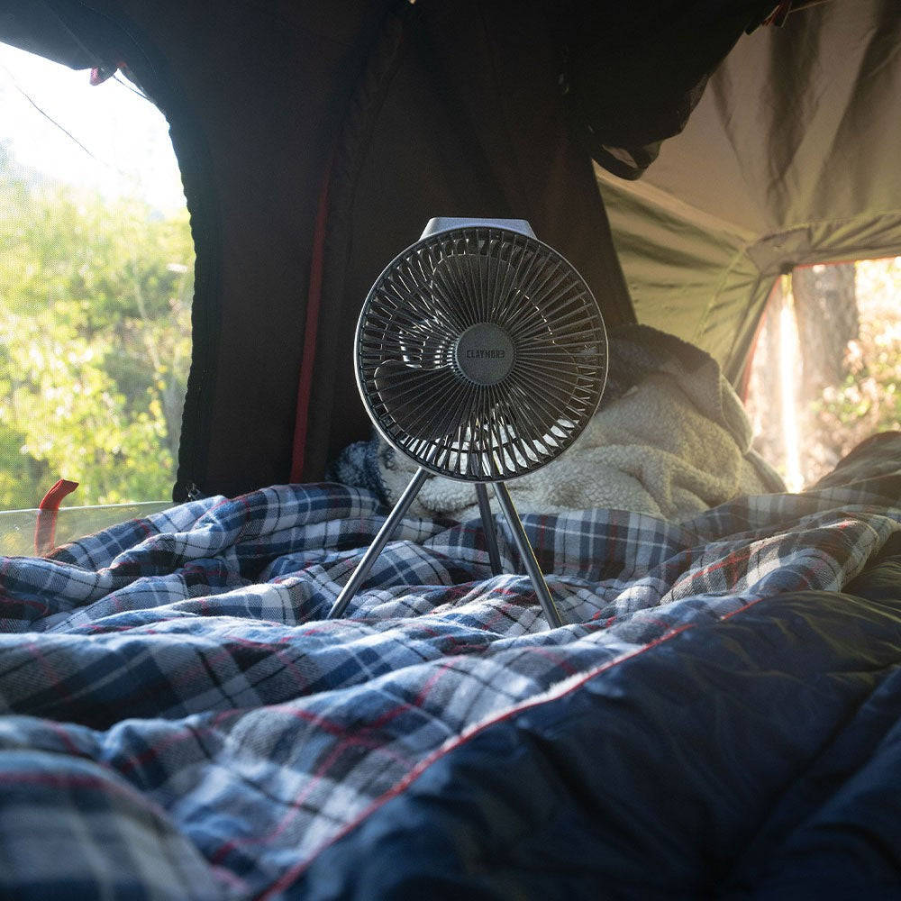 V600+ fan standing on bedding inside a rooftop tent in morning light