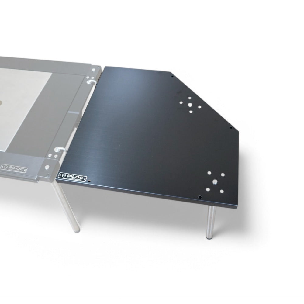 Black Biloc corner table joined to an IGT table, seen from the corner. The host table is a separate purchase.
