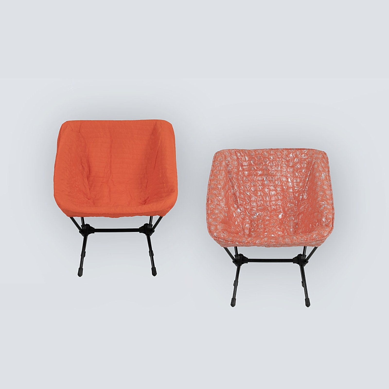 DEOS Chair Warmer in orange — quilted face and heat-reflective side on a camp chair