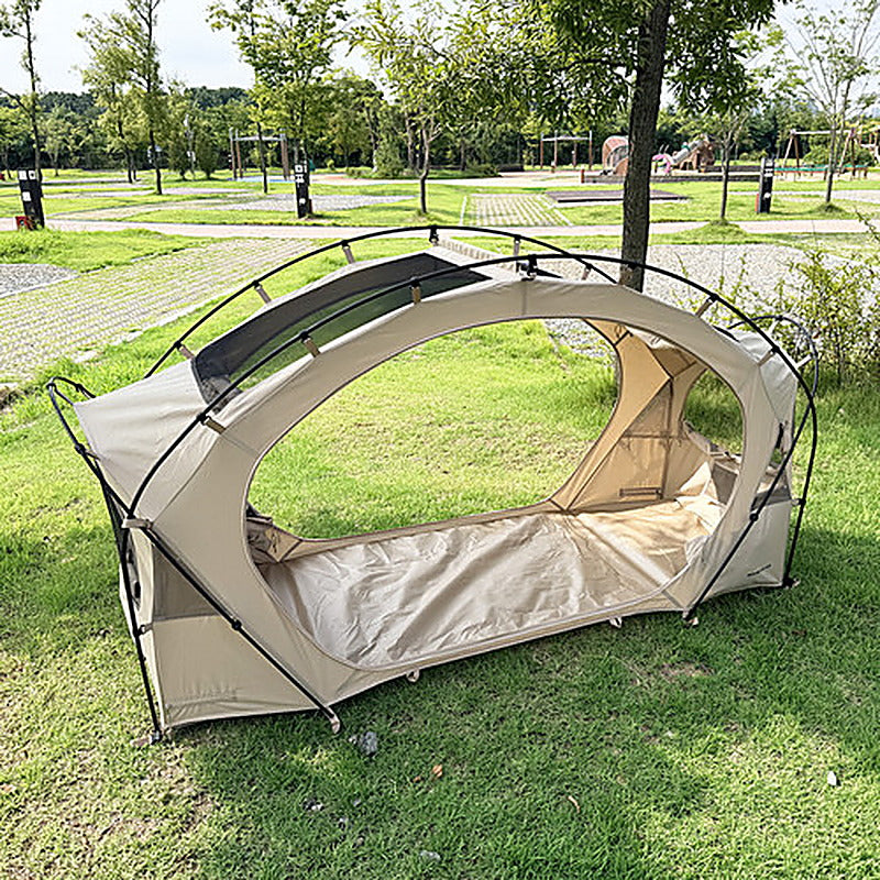Neo Nest 80 pitched directly on grass in ground mode, doors open, with a park lawn behind it.