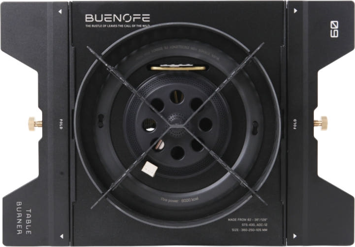 BUENOFE Stove Windscreen installed around the BX-09 Table Burner head and dropped flat into an IGT table frame, seen from directly above on a white background with the cross-shaped pot supports centered over the burner.