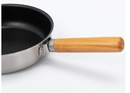 Close-up of the fry pan with its wood handle attached via screw-lock fitting
