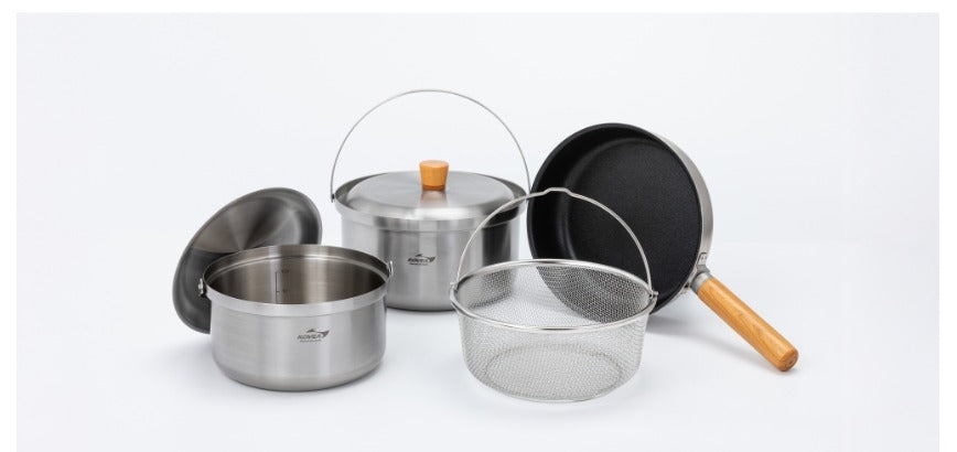 Full cookware set: two stockpots, fry pan, and mesh strainer arranged together
