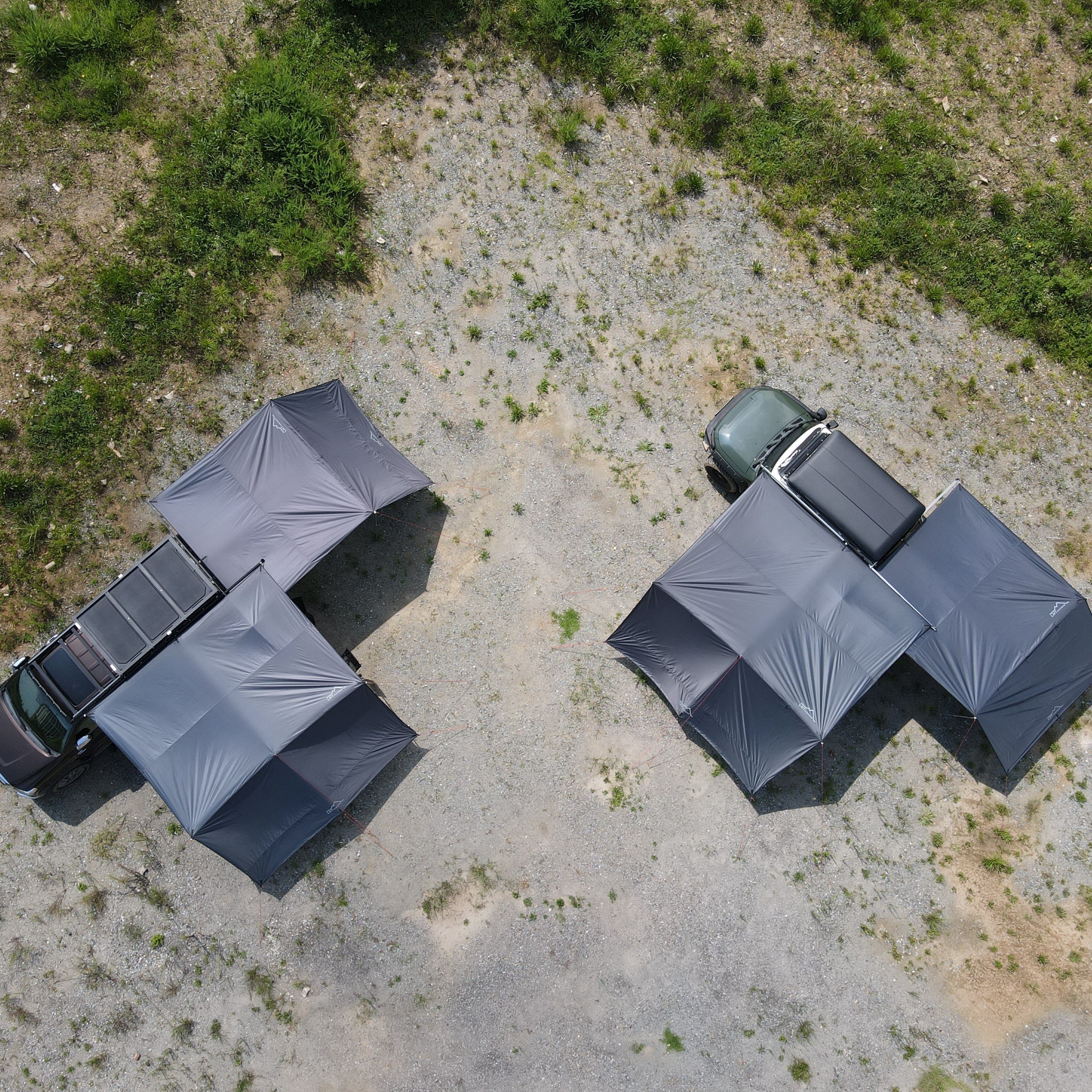 The drone shot of ES Awning Set 2000 and 1300 are fully pitched on the ground.