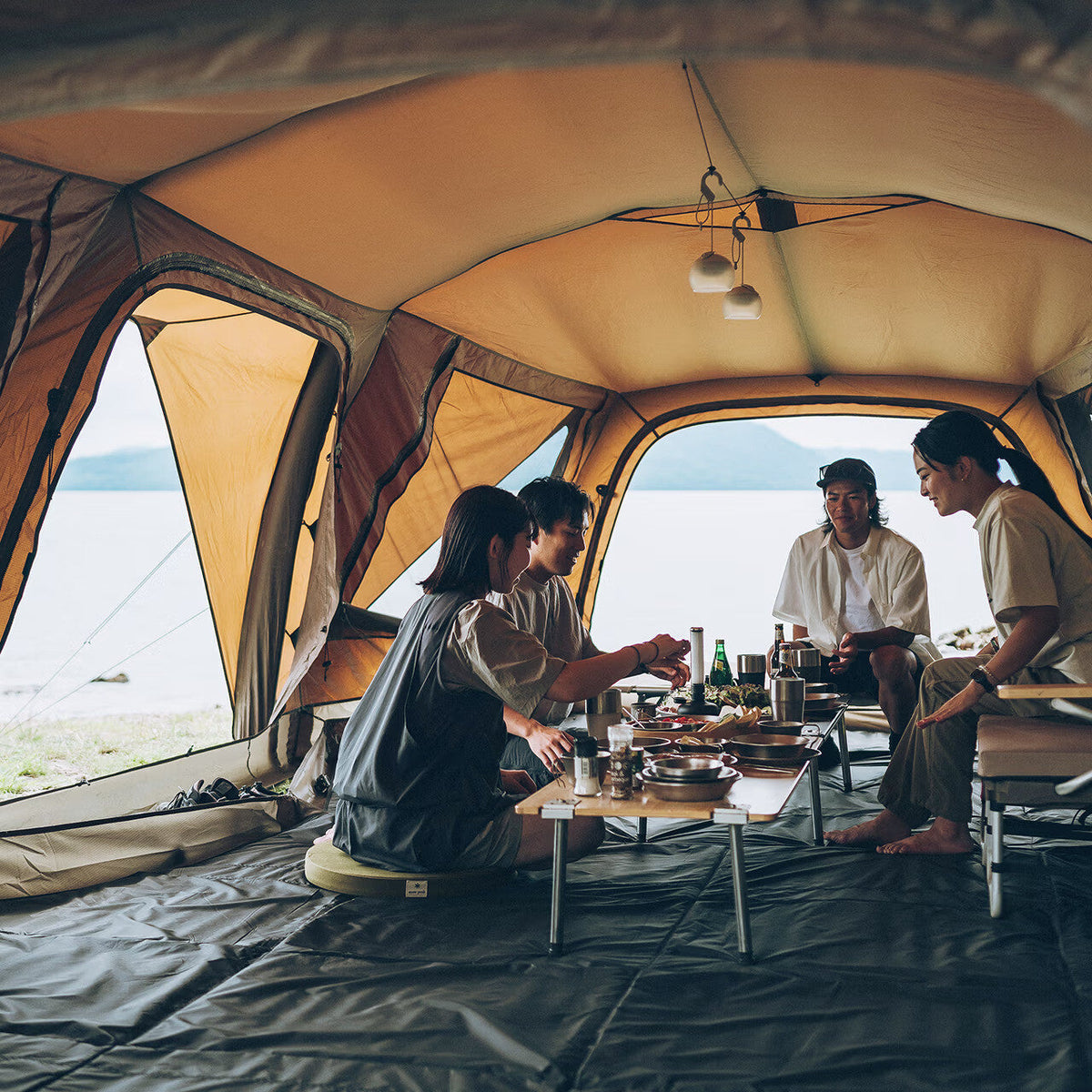 Aero Cumulus Shell, Brown, four people dining inside with a lake view