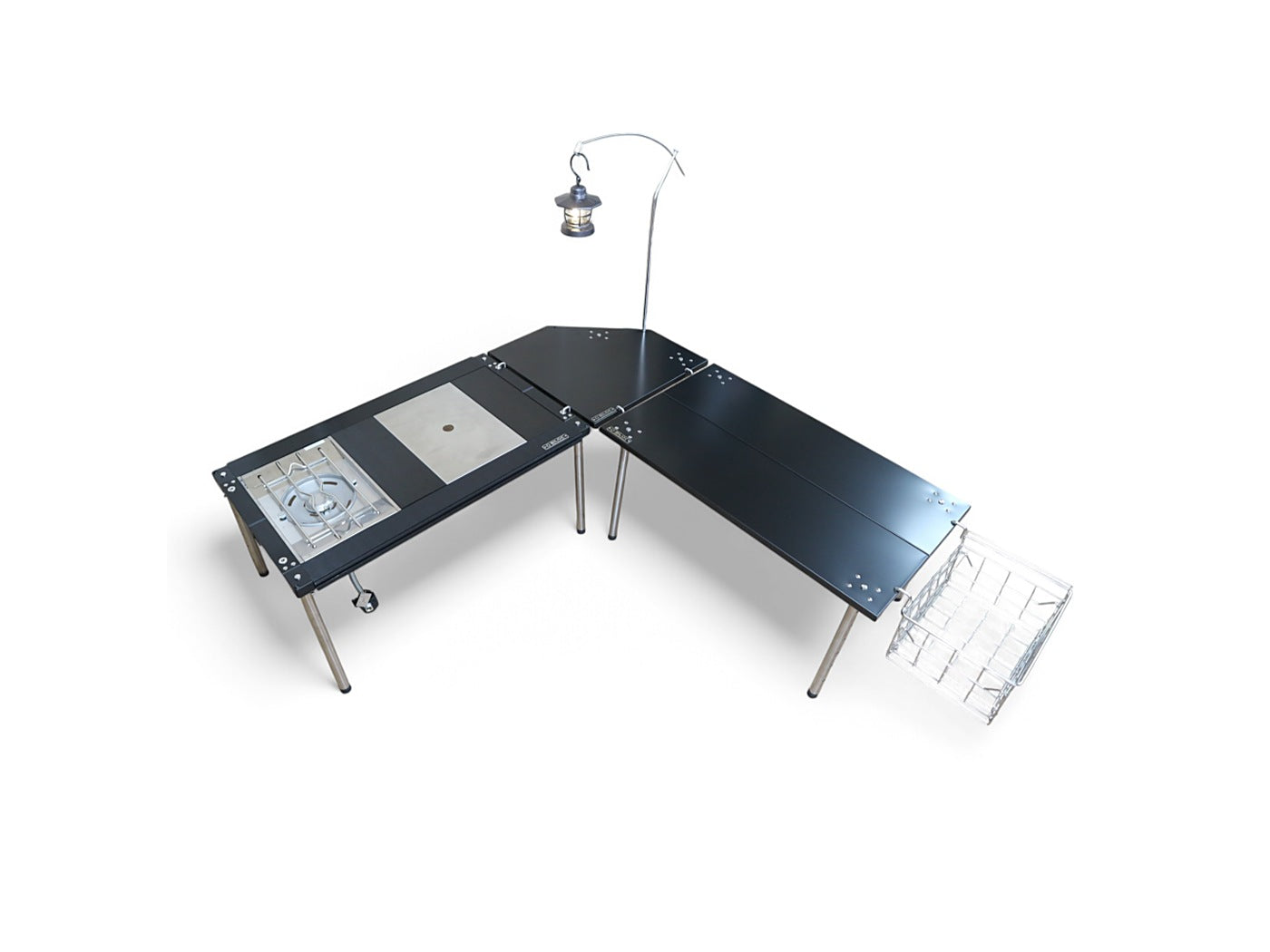 L-shaped camp kitchen made of two IGT tables joined by the corner table, with a lantern arm and wire basket mounted. The tables, lantern and basket are separate purchases.