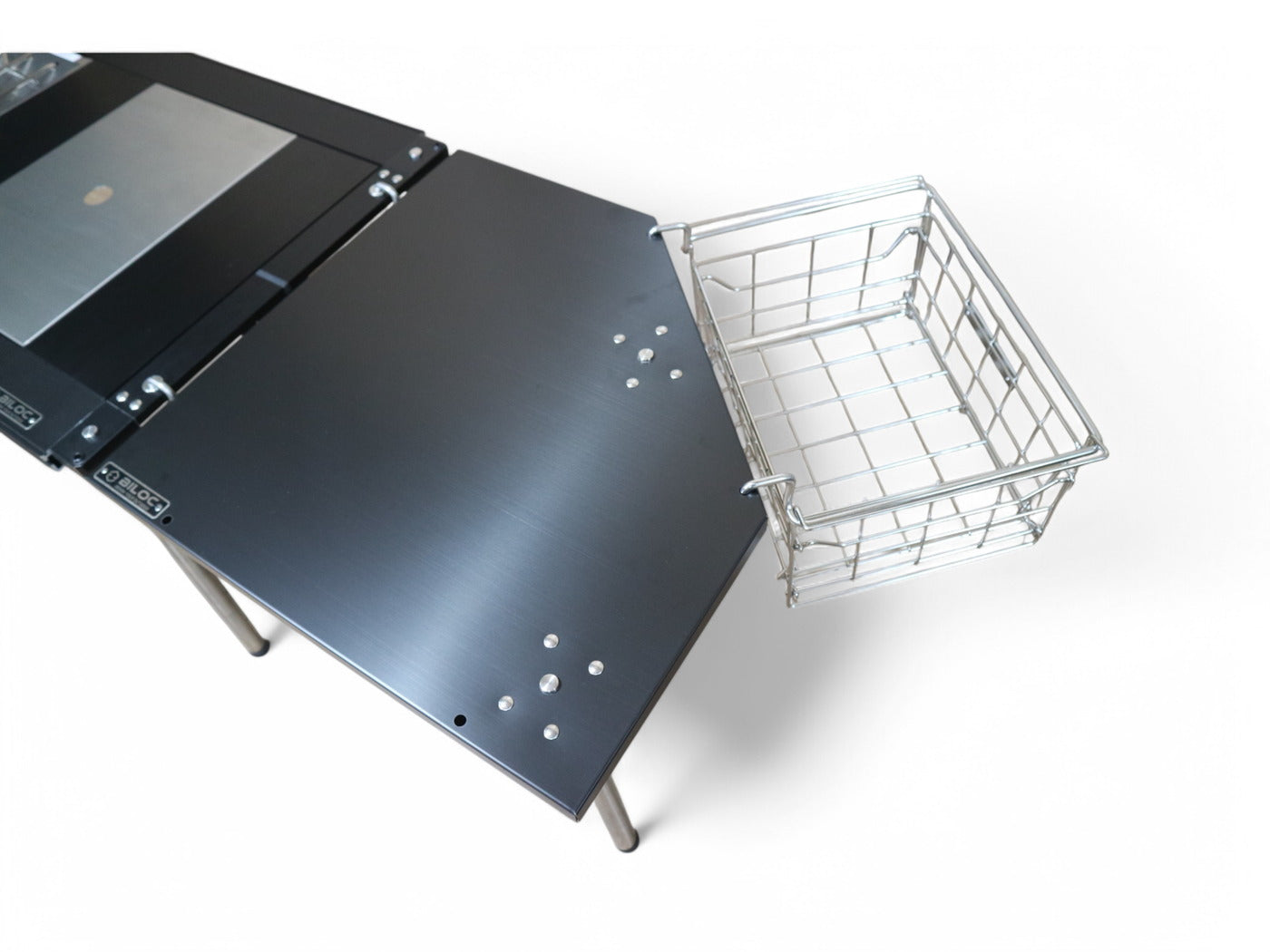 Wire basket hung from the standard IGT side holes on the edge of the Biloc corner table.