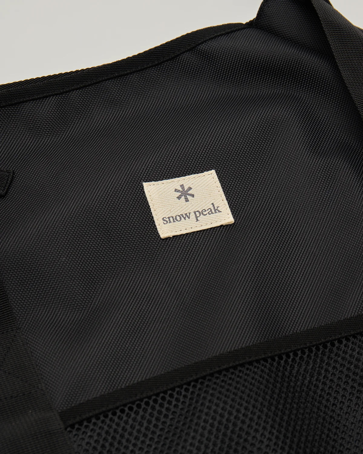 Close-up of the Snow Peak label on the Fireplace Bag L