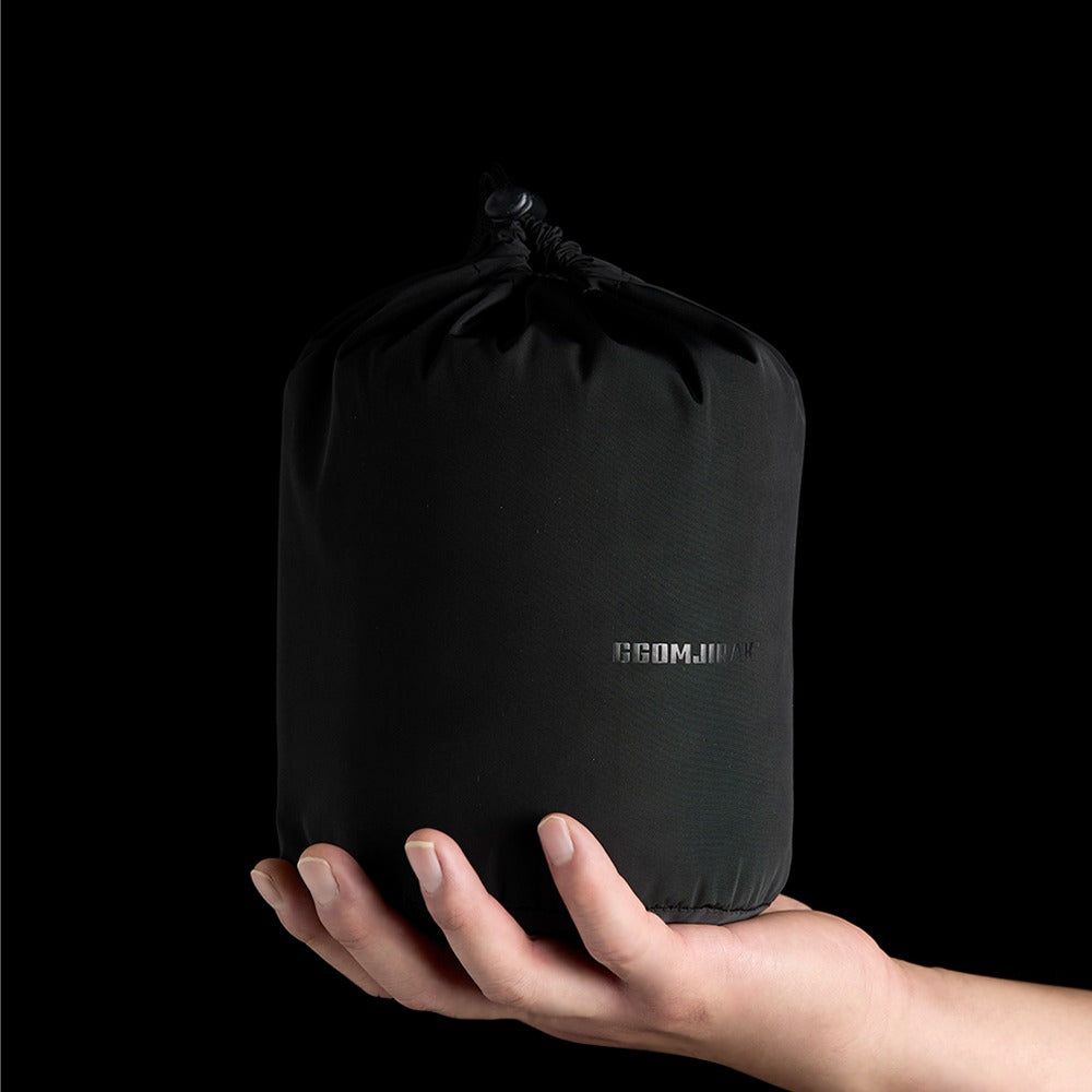 Carbon Heating Pad Large packed into its carry bag, held in one hand