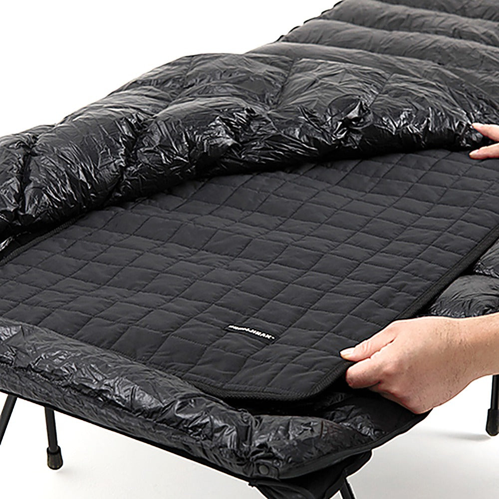 Carbon Heating Pad Large on a cot beneath a down sleeping bag