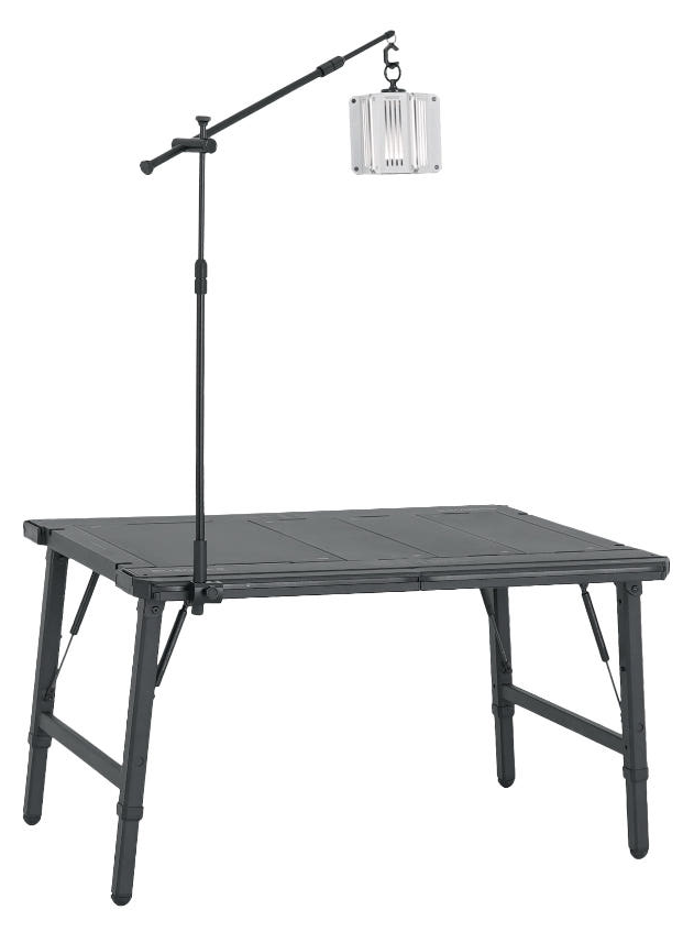 BUENOFE IGT Lantern Hanger clamped to a compact square camping table, the telescoping pole raised tall and the boom arm holding a lantern well above the tabletop, shown three-quarter on a white background.