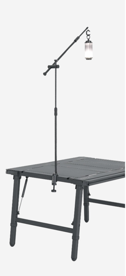 BUENOFE IGT Lantern Hanger set up on a folding IGT-style camping table in a three-quarter studio view, the angled boom arm suspending a lantern high over the work surface to show the full assembled system on a white background.