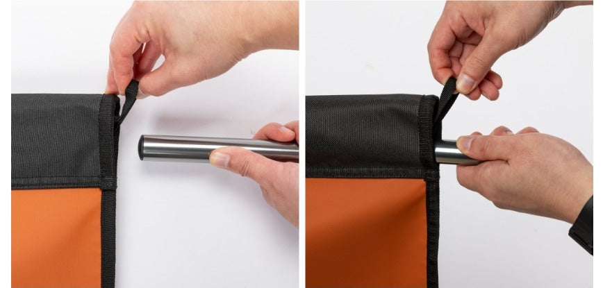 Sliding the side bar into the cot bed's side sleeve