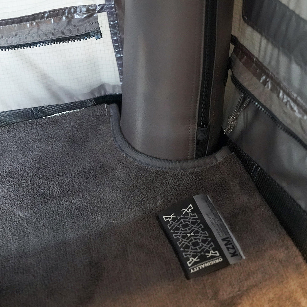 Edge of the T-250 rug mat rising up the tent wall to block condensation