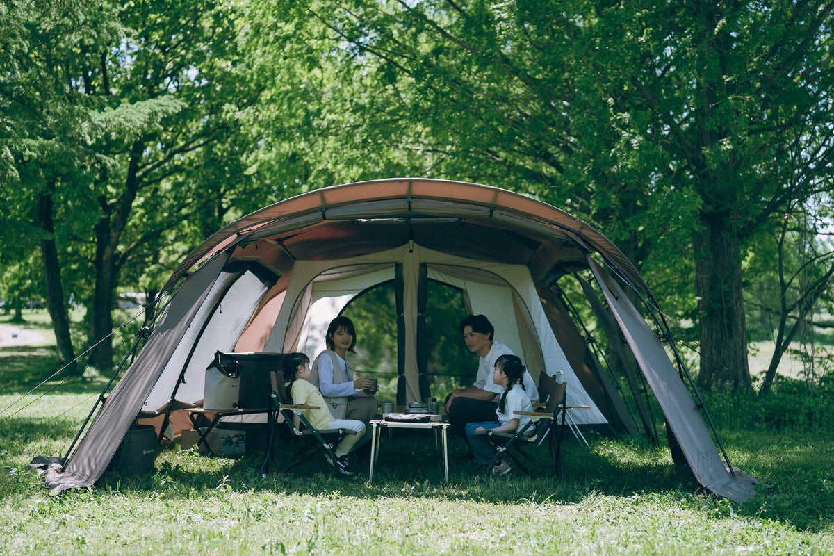 Land Lock X, Brown, wide open front with campers seated inside among trees