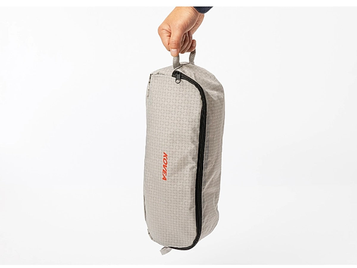 Light Chair X packed in its compact storage case, held in one hand