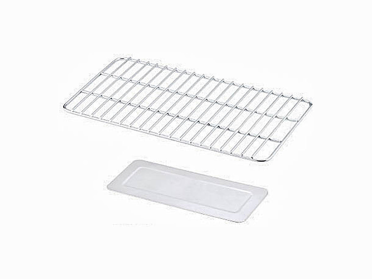 Grill-form charcoal tray above the solid ash tray on white
