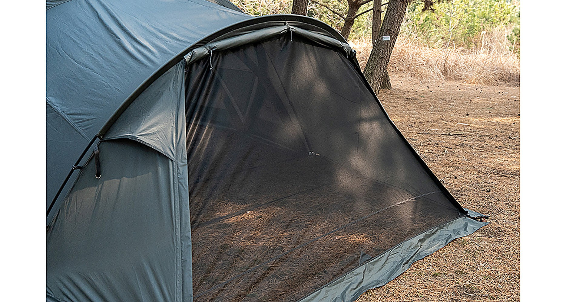 Exterior view of the Forest Charcoal vestibule front entry with the door panel and mesh visible