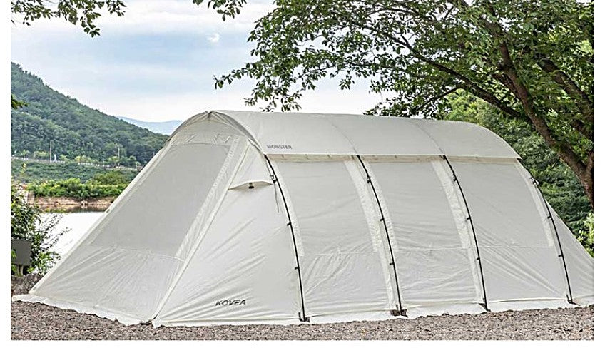 Monster tunnel tent pitched at a riverside campsite