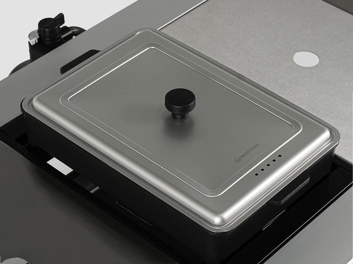 The hot pot pan cover seated on the hot pot pan inside an Add-on Multi Burner