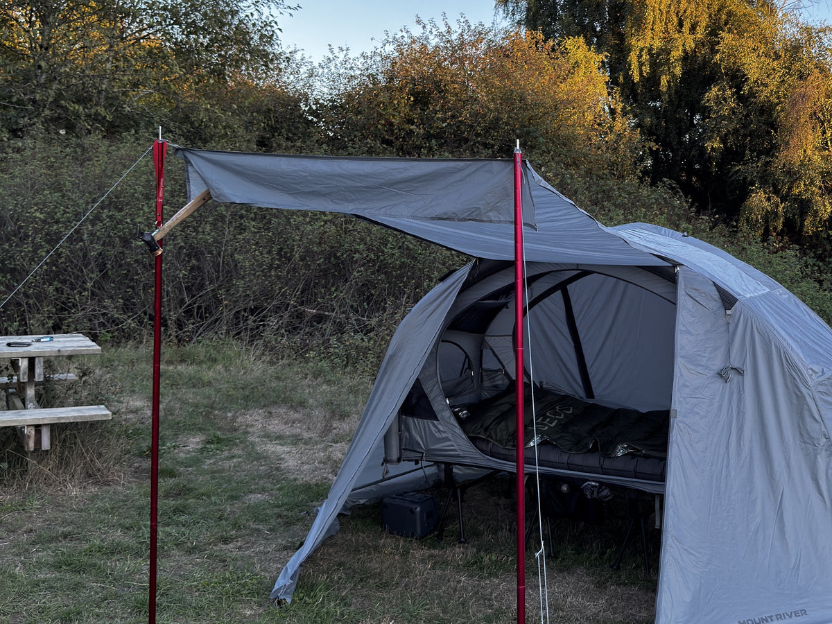 Air rainfly with its door raised as an awning on two door poles, in a field (tent, cot and poles sold separately).