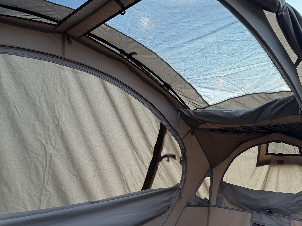 Looking up from the Sky Mat inside the Neo Nest 80 at the mesh ceiling and both oval windows (cot and pad sold separately).