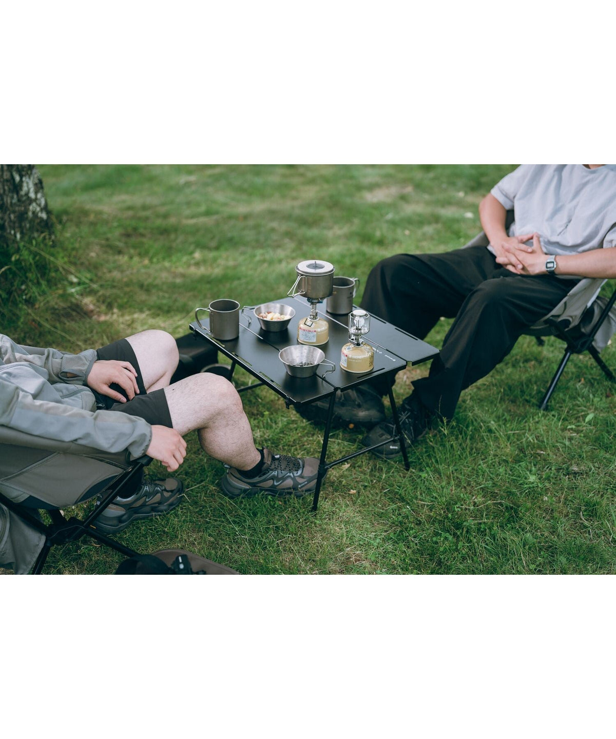 Noga Table, Black, in use at a relaxed camp seating area