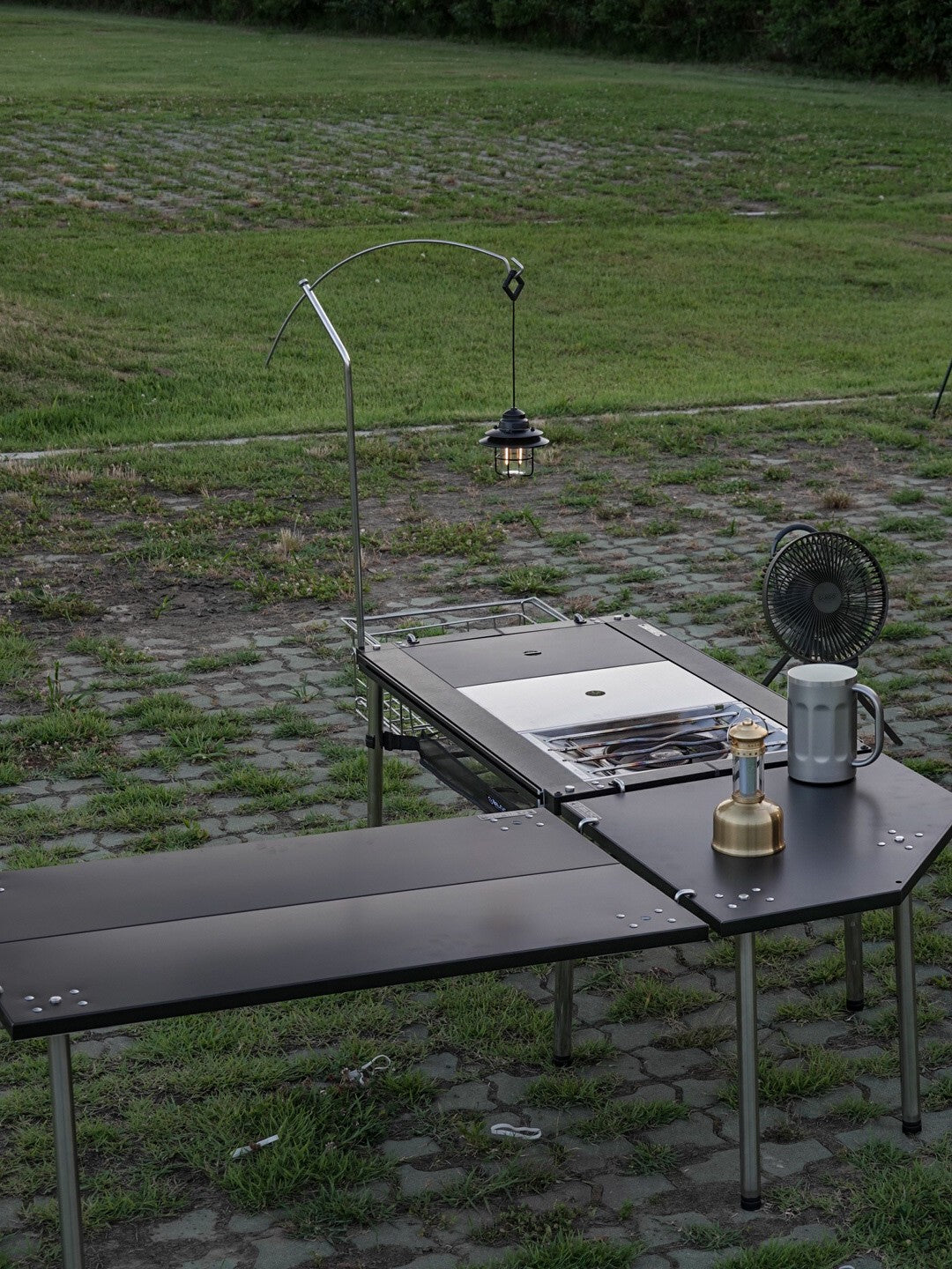 Black Biloc Ribera table extending an IGT kitchen table in line at a campsite