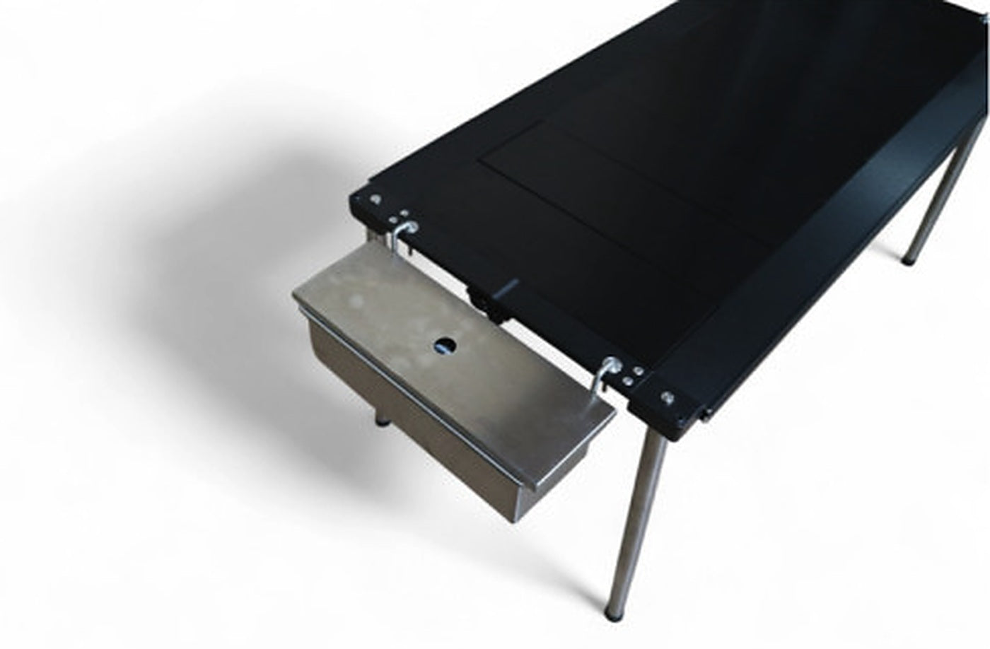 Side hanger hooked over a table rail carrying a stainless tray below the edge.