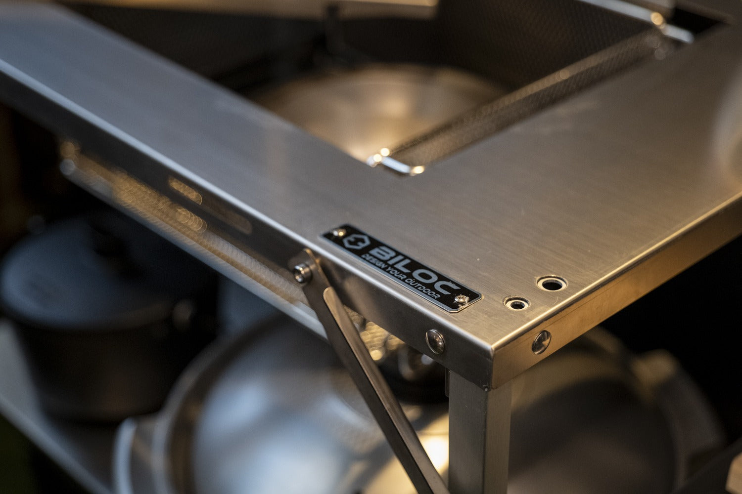 Close-up of the BILOC nameplate on the Stella shelf edge and the folding linkage behind it.