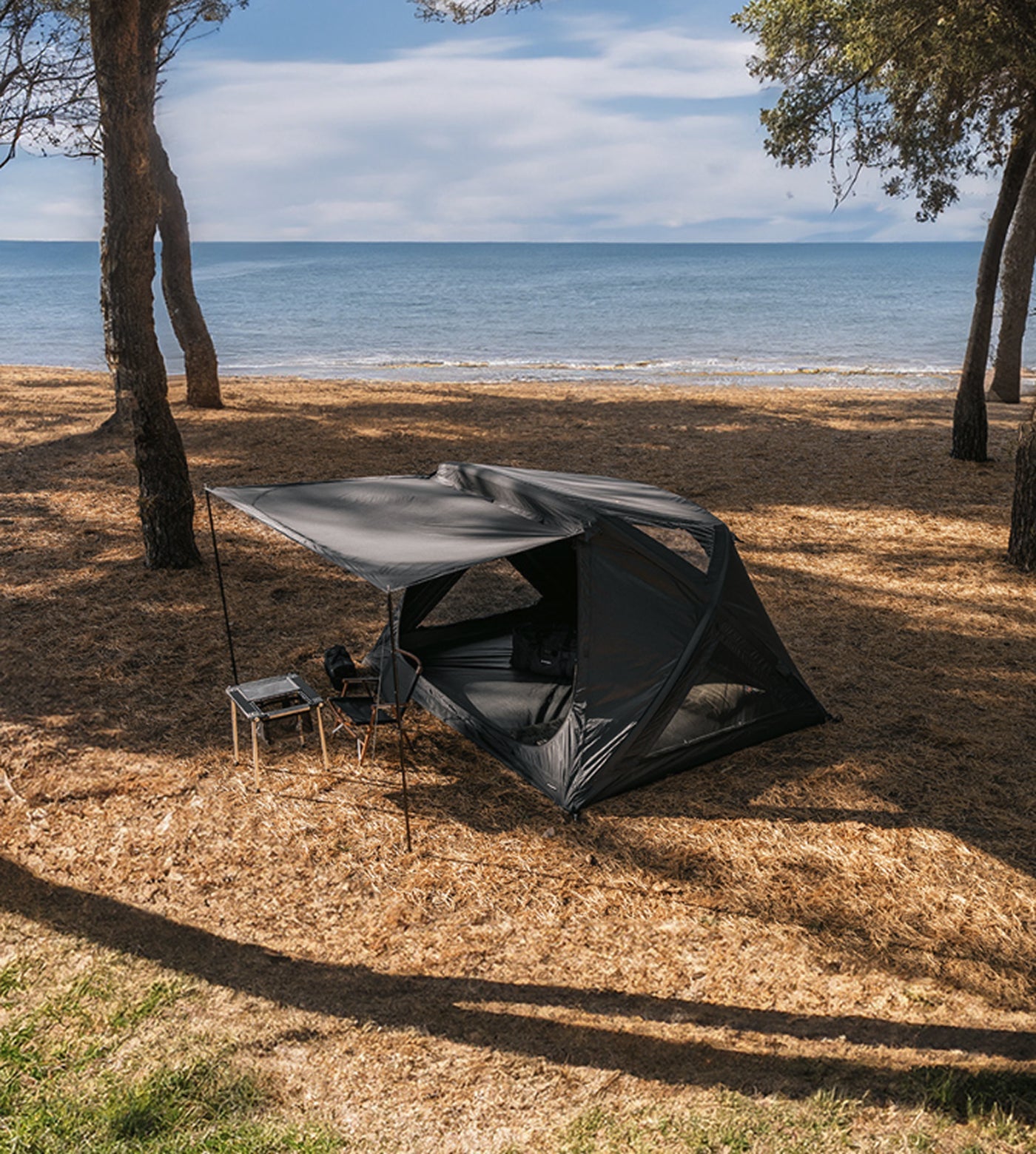 Interior shot showing camping chairs, air mattress, and full headroom with the triangular TPU skylight panel above