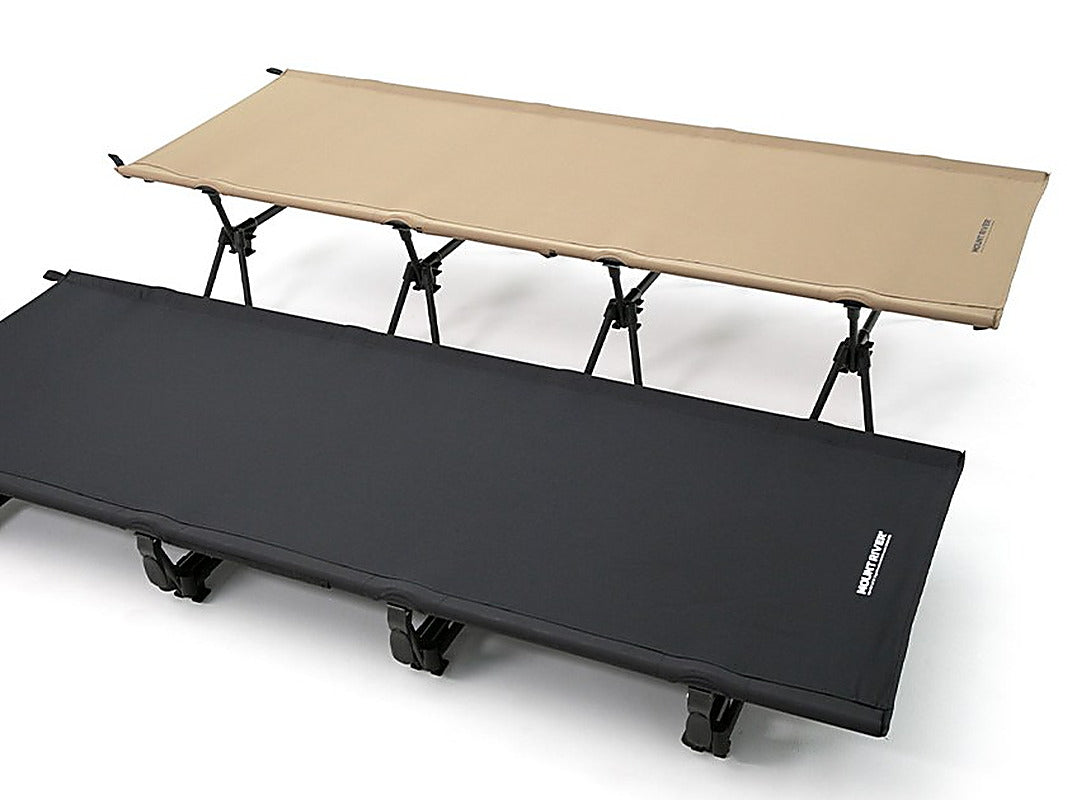 Tan Wide Cot 80 set to high mode behind a black Wide Cot 80 in low mode, studio view (second cot sold separately).